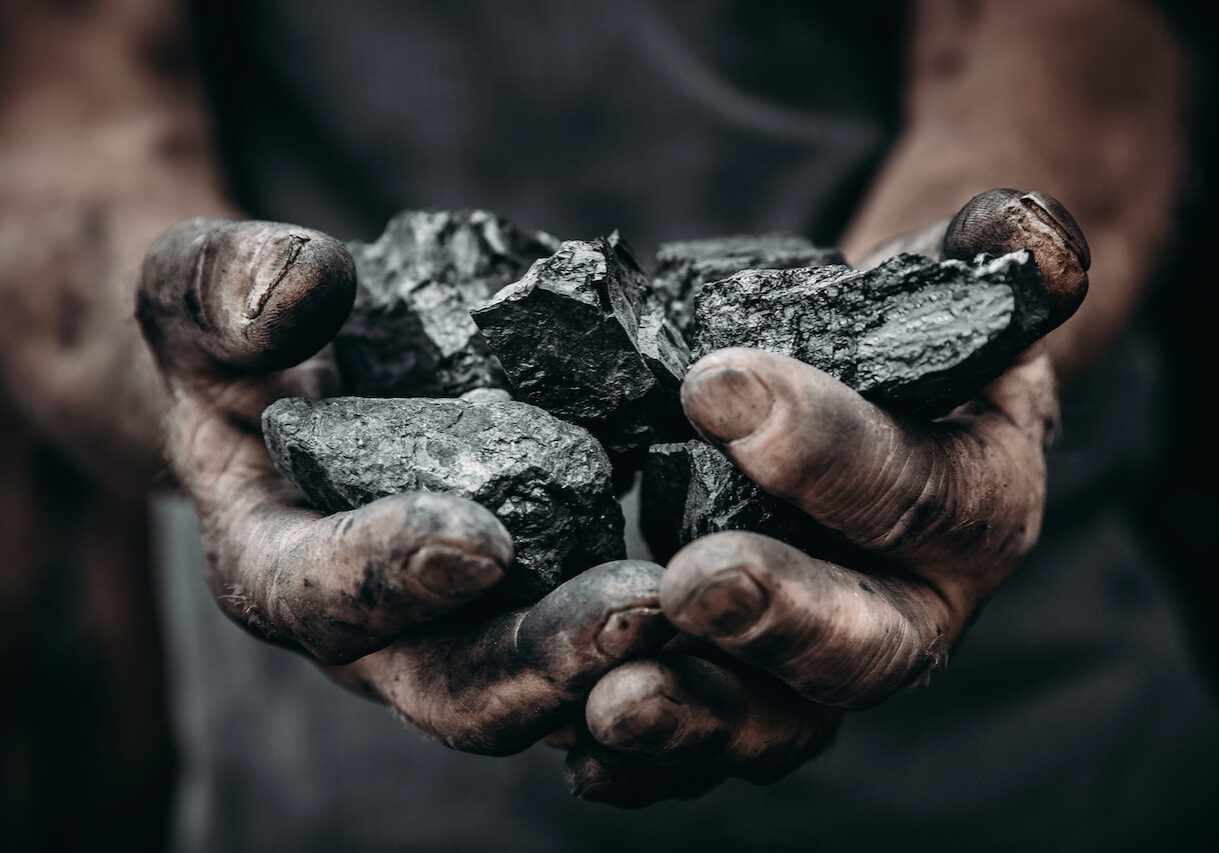 Coal in miner holds. Concept industry mining.